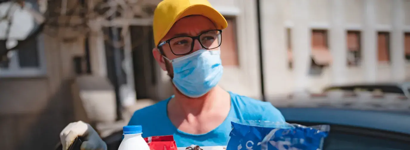 man participating in mutual aid while wearing mask